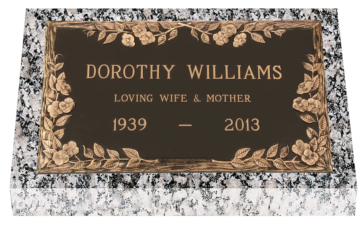 Cast bronze marker mounted on a granite foundation, seen from the front