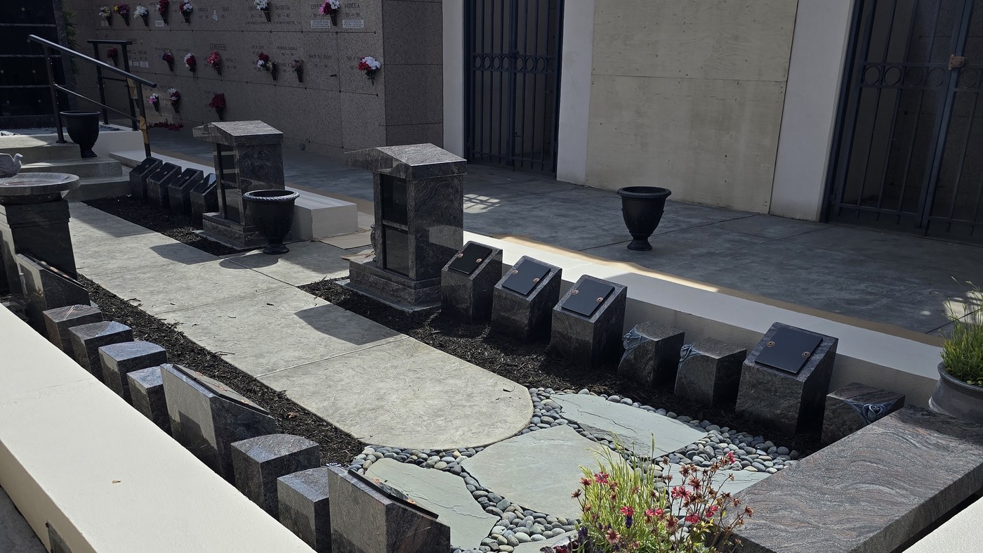The Terrace Garden Memorial Path: granite posts and benches along the flagstone path below the niche wall