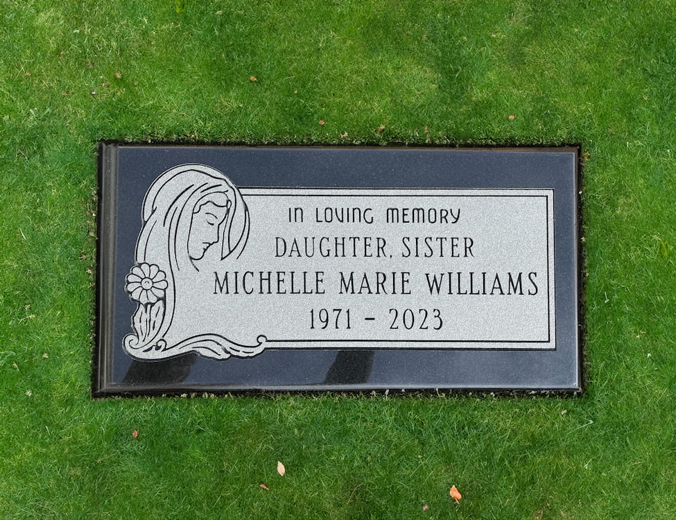 Flush granite marker set level with the lawn at Washington Memorial Park