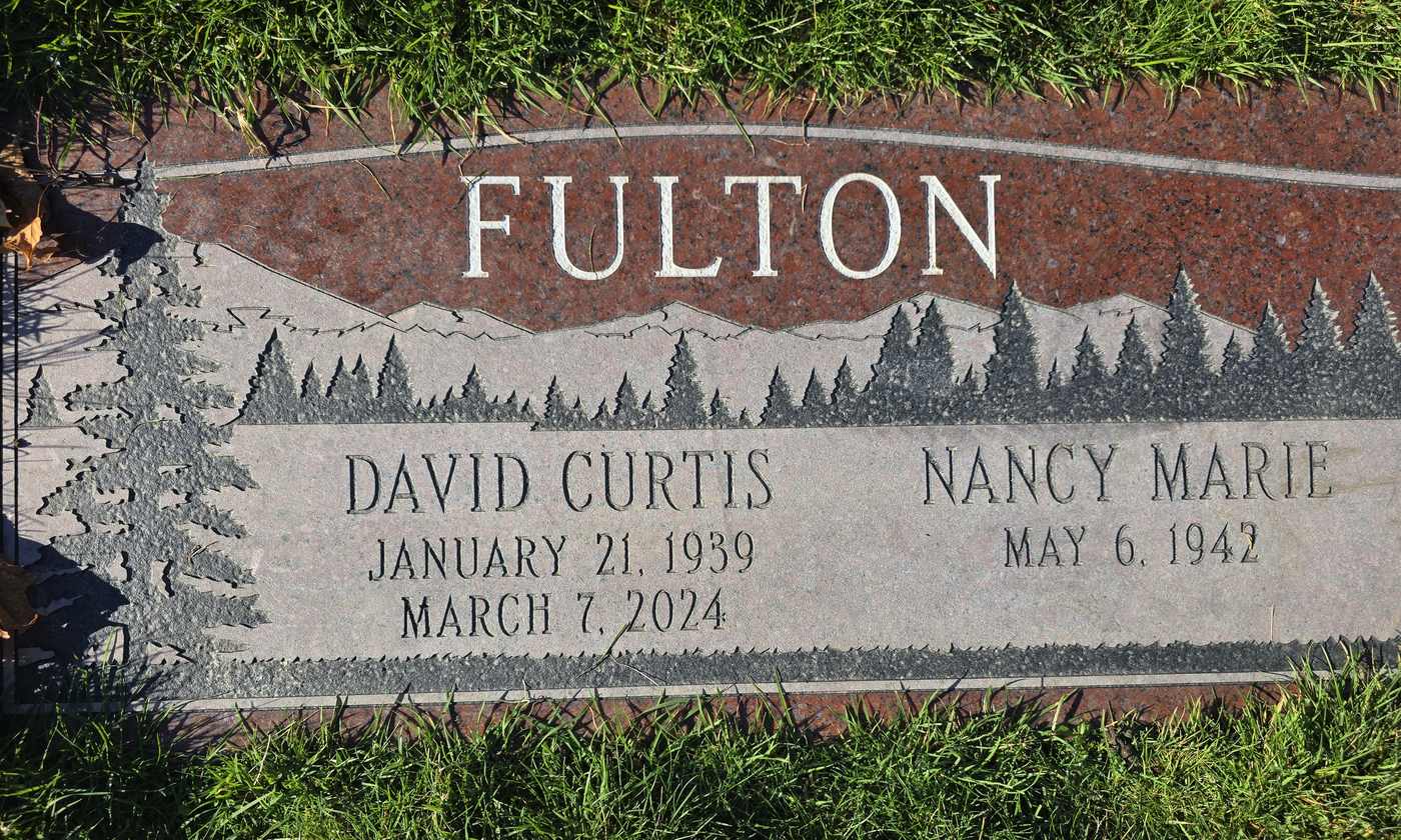 Red granite companion with an etched mountain treeline