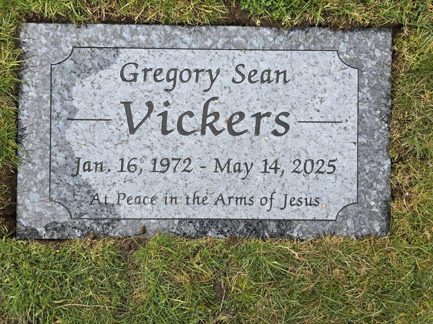 Light grey granite, script lettering and a carved corner panel