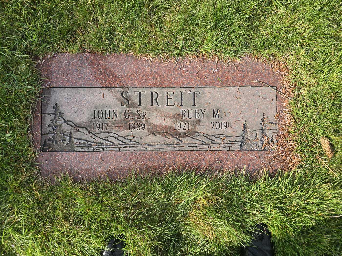 Red granite with an etched forest scene