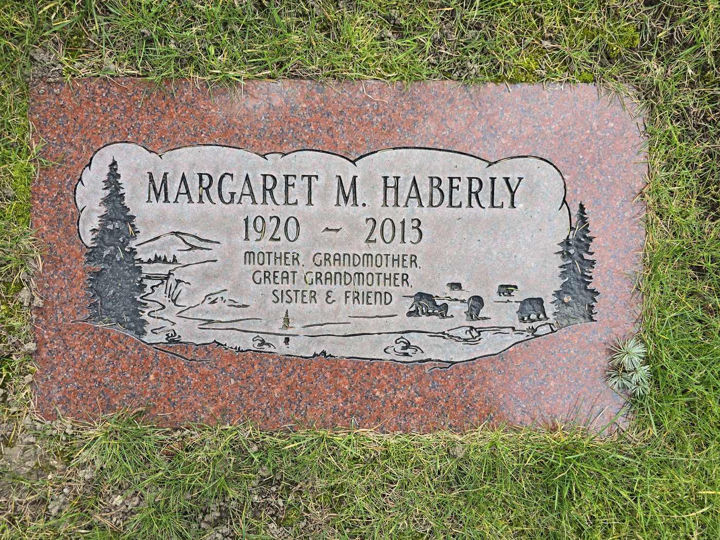 Red granite with an etched wilderness scene