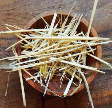 A wooden bowl of straw